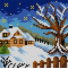 a cross stitch christmas scene with a house in the snow