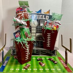 two bags filled with candy sitting on top of a table next to a football field