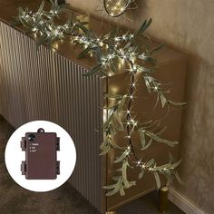 a christmas tree with lights on it next to a radiator