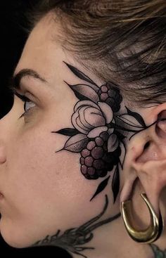 a woman with tattoos on her neck and behind the ear is a flower tattoo design