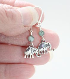 "These cute and beautiful sterling silver elephant earrings are handcrafted by me. Perfect teen daughter gift from Mom or niece birthday gift! Sterling silver .925 elephant charms are wire wrapped to african turquoise 4mm stones. Ear wires are sterling silver and earrings hang 3/4\" from earlobe. Elephants are revered symbols in many cultures, as they are the largest living land mammals. In feng shui they represent strength, protection, wisdom, and good luck! Metaphysical properties of african t Sterling Silver Nickel-free Earrings For Gift, Nickel Free Sterling Silver Earrings For Gift, Nickel-free Sterling Silver Earrings As Gift, Nickel-free Sterling Silver Earrings For Gift, Sterling Silver Dangle Earrings As A Gift, Nickel Free Dangle Earrings As Gift For Her, Bohemian Sterling Silver Earrings For Gift, Sterling Silver Wire Wrapped Earrings As Gift, Unique Nickel-free Earrings As Gift