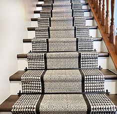 the stairs are decorated with black and white rugs