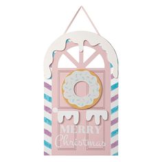 a pink door with a donut hanging from it's side and merry christmas lettering on the front