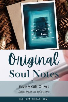 a hand holding a pen next to an art piece with pine cones in the background and text, original soul notes give a gift of art select from the collections