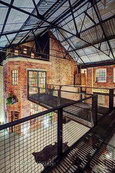 the inside of a building with glass walls and metal railings on top of it