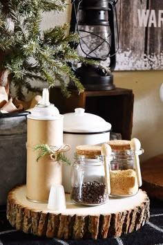 a wooden table topped with jars filled with spices and seasoning next to a christmas tree