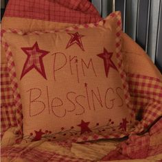 a red and white pillow with the words pam blessing on it sitting on a bed