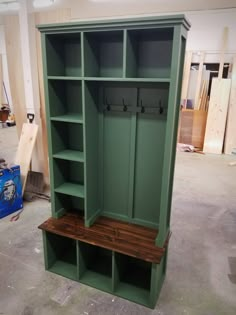 a large green cabinet with two benches in it