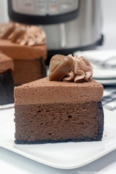 a piece of chocolate cake on a plate with an instant pressure cooker in the background