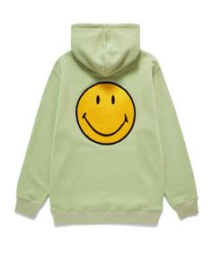 a green sweatshirt with a smiley face on it