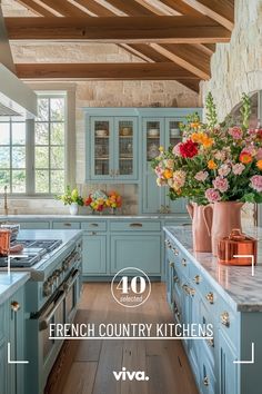 an image of a kitchen setting with flowers in vases on the counter and blue cabinets