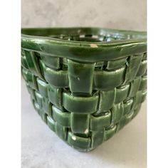 a large green basket sitting on top of a table