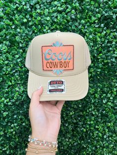 Saddle up with the Coors Cowboy Trucker Hat! This tan foam style hat features a playful Coors cowboy patch on the front. Perfect for any beer-loving cowgirl, this hat adds a touch of humor to any outfit. Giddy up and get yours today! Western Style Baseball Cap With Short Brim, Western Style Snapback Hat With Short Brim, Country Style Baseball Cap, Western Style 5-panel Trucker Hat For Rodeo, Casual Snapback Hat For Western-themed Events, Country Style Snapback Trucker Hat For Western Events, Country Style Trucker Hat For Western-themed Events, Trucker Snapback Hat With Short Brim For Rodeo, Country Style Baseball Cap For Western-themed Events