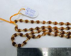 "22K solid Gold & Rudraksha beads strand Necklace. Length -22\"( we can adjust length) , weight -22.320 grams." Festival Mala With Polished Round Beads, Festival Mala With Polished Beads, Spiritual Mala With Polished Beads For Festive Occasions, Festive Spiritual Mala With Polished Beads, Round Polished Beaded Necklaces For Puja, Polished Round Beaded Necklace For Puja, Polished Beaded Necklaces For Puja, Polished Beads Mala For Puja, Gold Beaded Bracelet For Puja With Round Beads