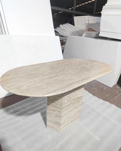 a table that is sitting on the ground in front of some white walls and flooring