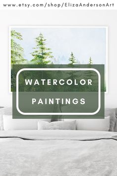 a bed with white sheets and pillows in front of a green sign that says watercolor paintings