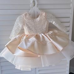 I Bought This Dress For My Granddaughter For A Wedding. It Was Supposed To Be Champagne And For A 2t. I Came And Was More Of A Peacy Then The Tan Look We Were Hoping For. Also It Fit A Little Larger. My Other Granddaughter Is A Size 3t And It Fit Her Perfect. The Dress Is Brand New. Never Worn Other Than Trying On. Great Condition Fitted Cream Princess Dress For Pageant, Fitted Cream Princess Dress For Pageants, Cream Fitted Princess Dress For Pageant, Cream Princess Dress For Pageants, Fitted Cream Dress For Pageant, Long Sleeve Ruffled Tutu Dress For Baptism, Fitted Cream Princess Dress, Cream Long Sleeve Princess Dress For Party, Peach Princess Dress With Ruffles