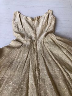 "Gold lame anyone???? This 50s dress is simple yet soooooooo darn cool. That black trim just elevates this to next level glam! Condition: Excellent Bust 32\" Wait 22\" Length 36.5\" This item is clean and ready to wear. Comes from a smoke and pet free home. Don't forget to follow me on Instagram @tammaraclearshercloset for new listing alerts This is shipping from Singapore. Standard post to the US takes about 10 working days. Please contact me if you need it urgently." 1950s Style Fit And Flare Party Dress, Vintage Fit And Flare A-line Dress For Party, Fit And Flare A-line Vintage Party Dress, 1950s Style Party Dress With Lined Bodice, 1950s Style Lined Party Dress, Retro Fit And Flare Evening Dresses, Retro Fit And Flare Party Dress, Lined Vintage Dress For Party, Retro Party Dress With Lined Bodice