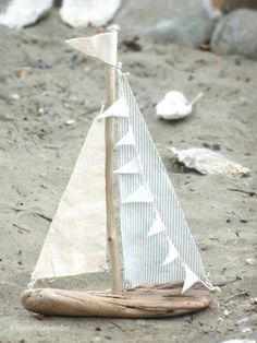 a small sailboat is sitting on the sand