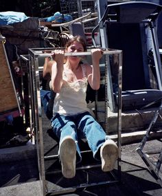 a woman sitting in a chair with her legs crossed