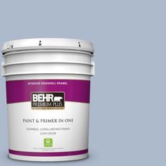 the behr paint and primer in one is shown on a dark brown background