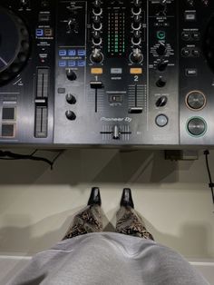 a person laying down in front of a sound board