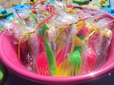 plastic forks and spoons in a pink bowl