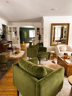 a living room with two green chairs in it