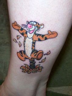 a person with a tiger tattoo on their leg and foot is standing in front of the camera