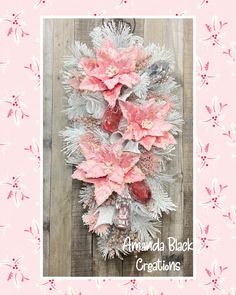 a pink and silver poinsettia wreath on a wooden background with the words amanda black creations