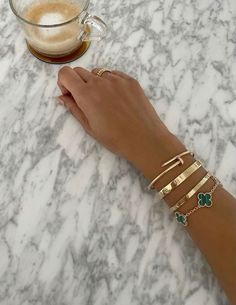 aesthetic gold bracelet stack designer bracelet stack cartier love bracelet van cleef aesthetic coffee bracelet ideas inspo Designer Bracelet Stack, Coffee Bracelet, Cartier Bracelets, Lucky Flower, Gold Bracelets Stacked, Accesories Jewelry