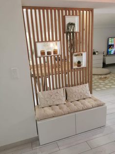 a living room filled with furniture and a flat screen tv mounted on the wall above it