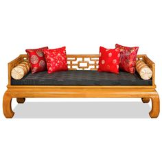 a wooden couch with red pillows on it's back and arm rests against a white background