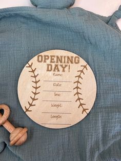 a baseball themed opening day sign with a wooden bat and ball on the back of it