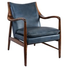 a black leather chair with wooden legs and arms, on a white background the chair has a dark blue upholstered seat