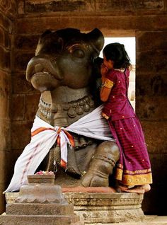 an elephant statue with a woman standing next to it and a quote on the back