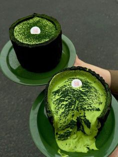 two green desserts sitting on top of plates