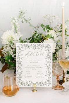 a table topped with wine glasses and a menu