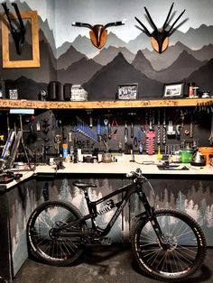 a mountain bike is parked in front of a workbench