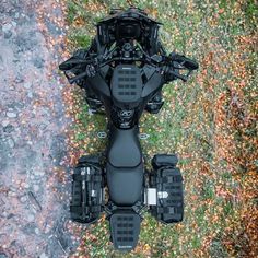 an aerial view of a four - wheeler parked on the ground in front of some leaves