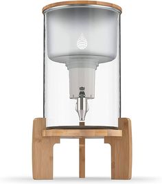 a water dispenser on a wooden stand with a glass cover over it