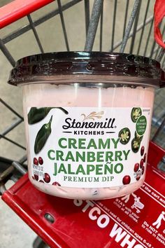 a jar of creamy cranberry jalapeno sits on a red cart