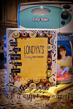 an easy bake recipe book sitting on top of a counter next to a toaster oven