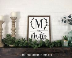 a mantle with candles, greenery and a sign that says the m is for mike