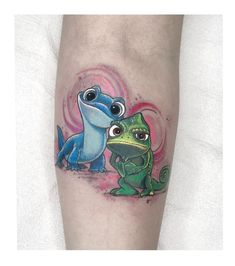 a tattoo on the leg of a person with a small lizard and a frog sitting next to each other