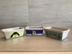 four ceramic dishes sitting on top of a counter next to each other with nativity scenes painted on them