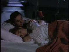 a man and woman laying in bed together