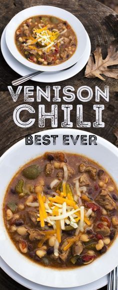 two white plates filled with chili and beans on top of a wooden table next to silverware