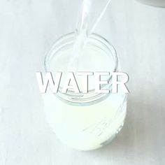 a glass filled with water sitting on top of a table