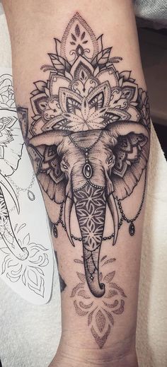 an elephant tattoo on the leg